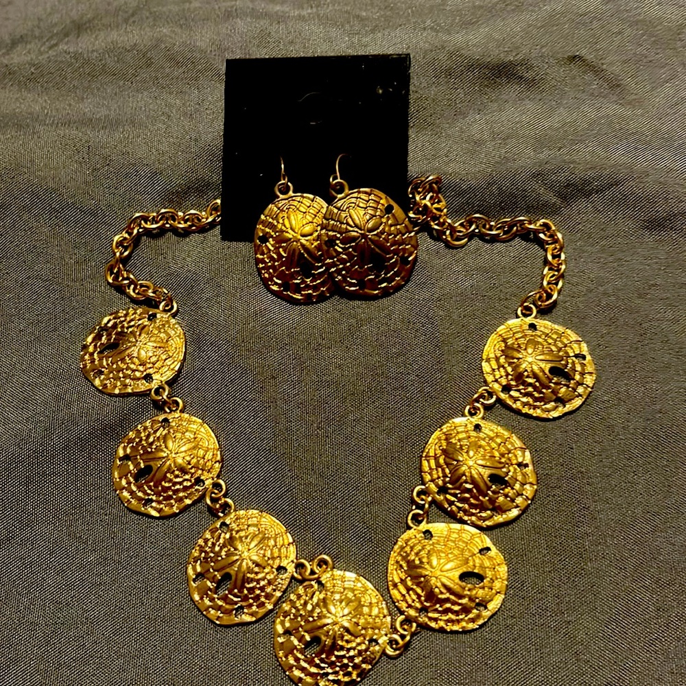 Matching sand dollar necklace and earrings.